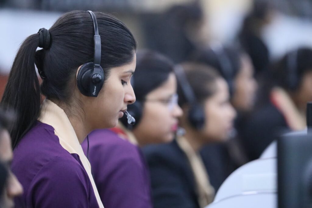 pexels photo 13062477 Call center agents wearing headsets working in a focused office environment.